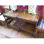 A pair of mahogany two tier whatnots, with turned baluster supports and lower tier drawer on ring