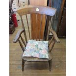 An ash and elm kitchen chair, with spindle back, turned arms, and turned legs joined by stretchers