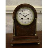 An Edwardian inlaid mahogany and brass mantel clock, the arched cased with brass pillars and ball