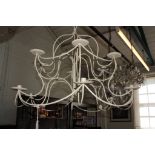 A painted metal two tier chandelier with 12 lights on scroll arms, 91cm diameter