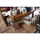 A pine and metal dressing table, with three frieze drawers on metal legs joined by a shaped