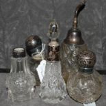 A collection of five silver topped perfume bottles