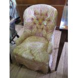 A Victorian button upholstered nursing chair with turned tapering legs and castors