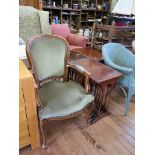 A nest of four mahogany tables and a green upholstered fauteuil in the French style