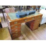 A yew wood and brass bound pedestal desk, the leather inset top over three drawers, the pedestals