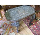 A carved padouk wood octagonal occasional table, heavily carved with acanthus scrolls and beasts, on