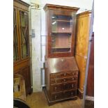 A George II style burr walnut and feather-banded bureau bookcase, the cavetto moulded cornice over a