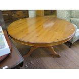 A pine breakfast table, the circular top on a tripod base of baluster stem and cabriole legs,