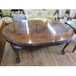 An early 20th century crossbanded mahogany extending dining table, the ovoid top with beaded edge