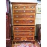 A George III style burr walnut and feather-banded secretaire chest on chest, with fluted canted