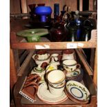 A Bohemian cranberry glass bowl on three scroll feet, a pair of Bohemian cranberry glass spill