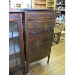 A mahognay and chequerbanded bow front chest of drawers, with six long graduated drawers on square