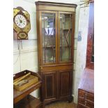 An Edwardian mahogany and satinwood crossbanded corner cabinet, the moulded cornice over two