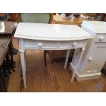 A painted bowfront dressing table with two frieze drawers and fluted tapering legs, 77cm wide