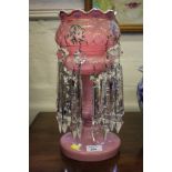 A Victorian pink glass table lustre with painted floral and gilt decoration, and cut glass