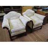 A pair of mahogany framed upholstered armchairs, with shaped back, the scroll arms carved with husks