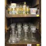 Fourteen glass chemistry bottles, a gilded glass water jug and glasses, a Poole Pottery vase, cup