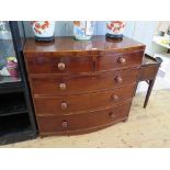 An early 19th century mahogany bowfront chest of drawers, the boxwood lined top over two short and