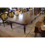 A large Early Victorian style mahogany banquet table, in the style of Gillows, the rectangular top