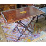 A burr walnut butlers tray, with patera inlay, and three quarter brass gallery, on a folding