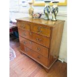 A George I style walnut and feather-banded chest of drawers, the quarter veneered top over a brush