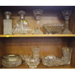 Two square cut glass decanters, a pair of cut glass candlesticks, and various glass vases and