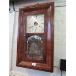 An American mahogany cased wall clock, with printed glass door, and painted dial, the twin train