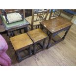 A nest of three oak tables with carved brackets and turned legs, 61cm wide