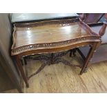 A George III style silver table, the shaped rectangular top with pierced gallery over a beaded