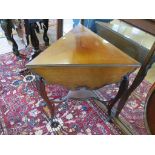 A late 19th century French mahogany triangular drop leaf tea table, the drop leaves with foliate