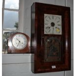 A 1920's walnut cased mantel clock, with foliate carved corners, the silvered dial enclosing a