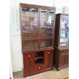 A Stag side cabinet and matching bookcase with two cupboard doors, open shelves and central