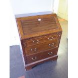 An Edwardian mahogany and satinwood crossbanded bureau, the panelled slope over three graduated