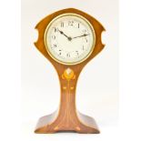 An Edwardian Art Nouveau style mahogany and boxwood strung mantel timepiece, the waisted case with