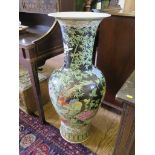 A pair of large famille noire vases of baluster form depicting exotic birds within bamboo and