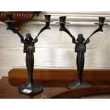 A pair of bronze Art Nouveau style twin branch candlesticks, the stems in the form of figures on a