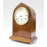 An Edwardian mahogany and chevron banded lancet arched mantel timepiece, with brass ball feet,