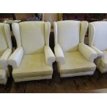 A pair of upholstered wing armchairs, on cabriole legs and club feet (2)
