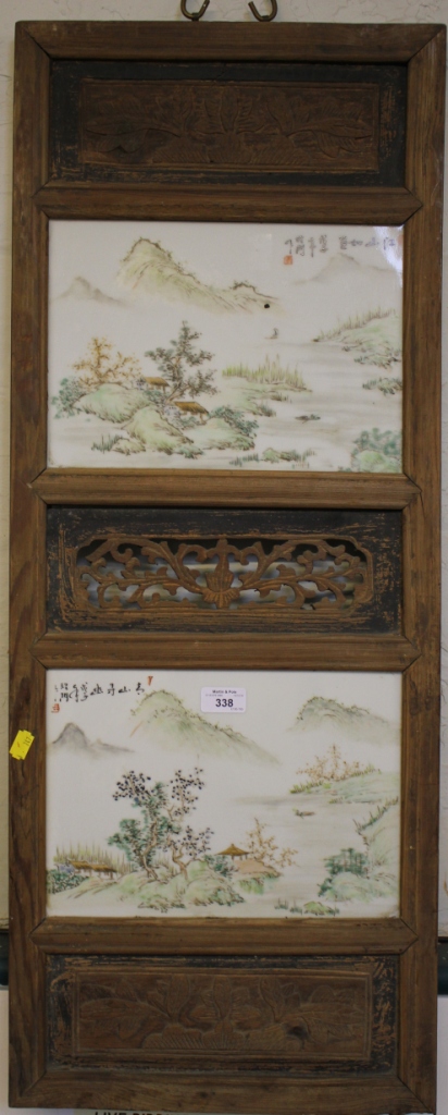 Two Chinese porcelain panels depicting landscapes and inscribed, set into a carved hardwood panel,