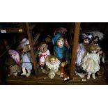 A collection of twenty-two dolls, mostly modern with bisque heads, including Shirley Temple doll,
