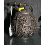A Chinese bronze vessel, with loop handle, two openings and profusely cast panels of figures, seal