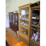 An oak Riva Colonia display cabinet, the glazed door enclosing shelves and two drawers, above two