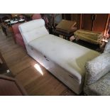 A late Victorian upholstered ottoman/chaise longue with scrolled arm and double hinged seat, on