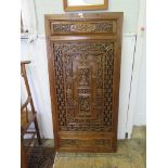 A pair of Chinese carved hardwood screens, the twin central panels depicting deities surrounded by