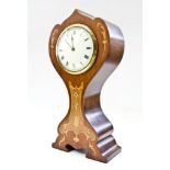 An Edwardian Art Nouveau style mahogany and inlaid mantel timepiece, of shaped waisted form with