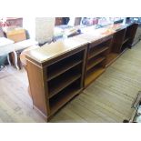 A pair of reproduction yewwood open bookcases 92cm wide, and another similar with crossbanded top,