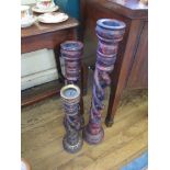 A set of three polychrome wooden standing candlesticks, graduated, each with intertwined barleytwist