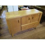 A G-Plan 'Brandon' oak sideboard, 1950's with a pair of cupboard doors over a drawer beside a