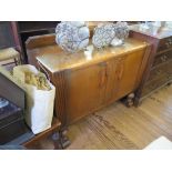 An 1930s oak sideboard, with two reeded doors on globular supports and bracket feet, 122cm wide