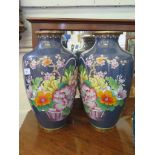 A pair of large Chinese cloisonne vases, depicting baskets of chrysanthemums on a blue ground,